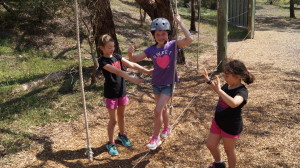 Lilly on the low-ropes with dedicated spotters